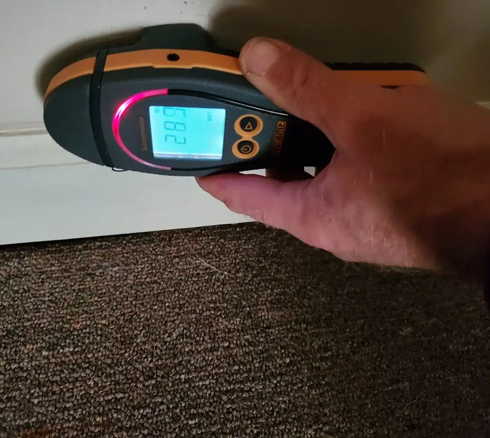Moisture detection at baseboard during Storm Damage Restoration in Fate